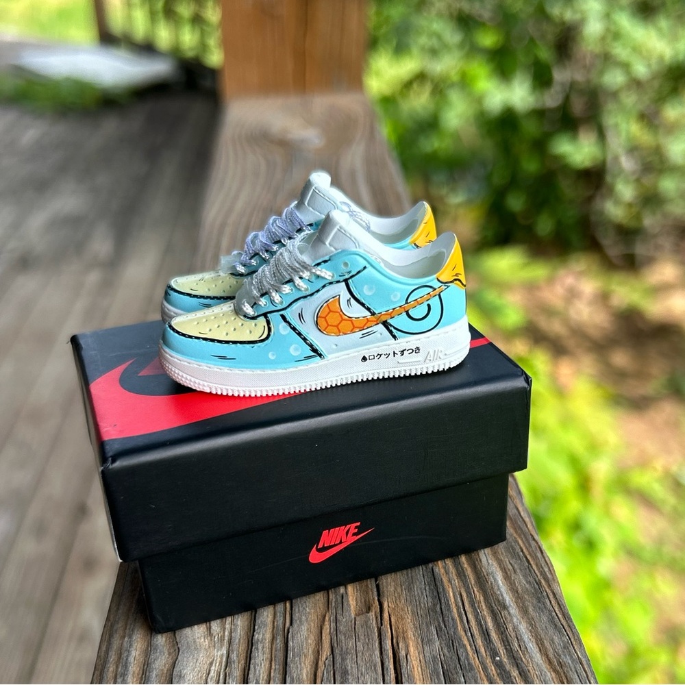 Pokeman mini Nike Low-Top Sneakers in Light Blue, Yellow & Orange